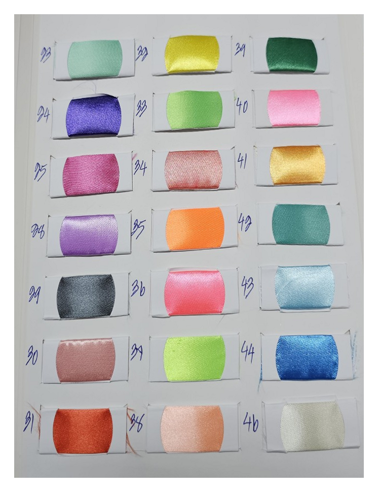 Crepe satin color chart page 2 with original fabric swatches and handwritten color codes / ตารางสีผ้าเครปซาตินหน้า 2